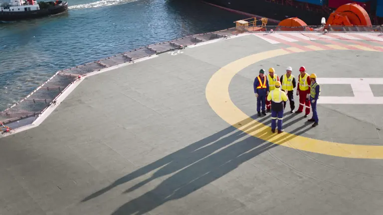 OMV employees on a helicopter landing pad